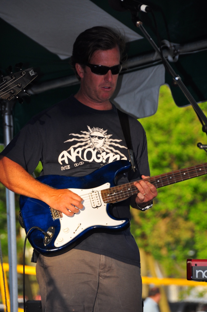 Peter Stuart, local rowayton realtor playing guitar with Assembly of DUST.